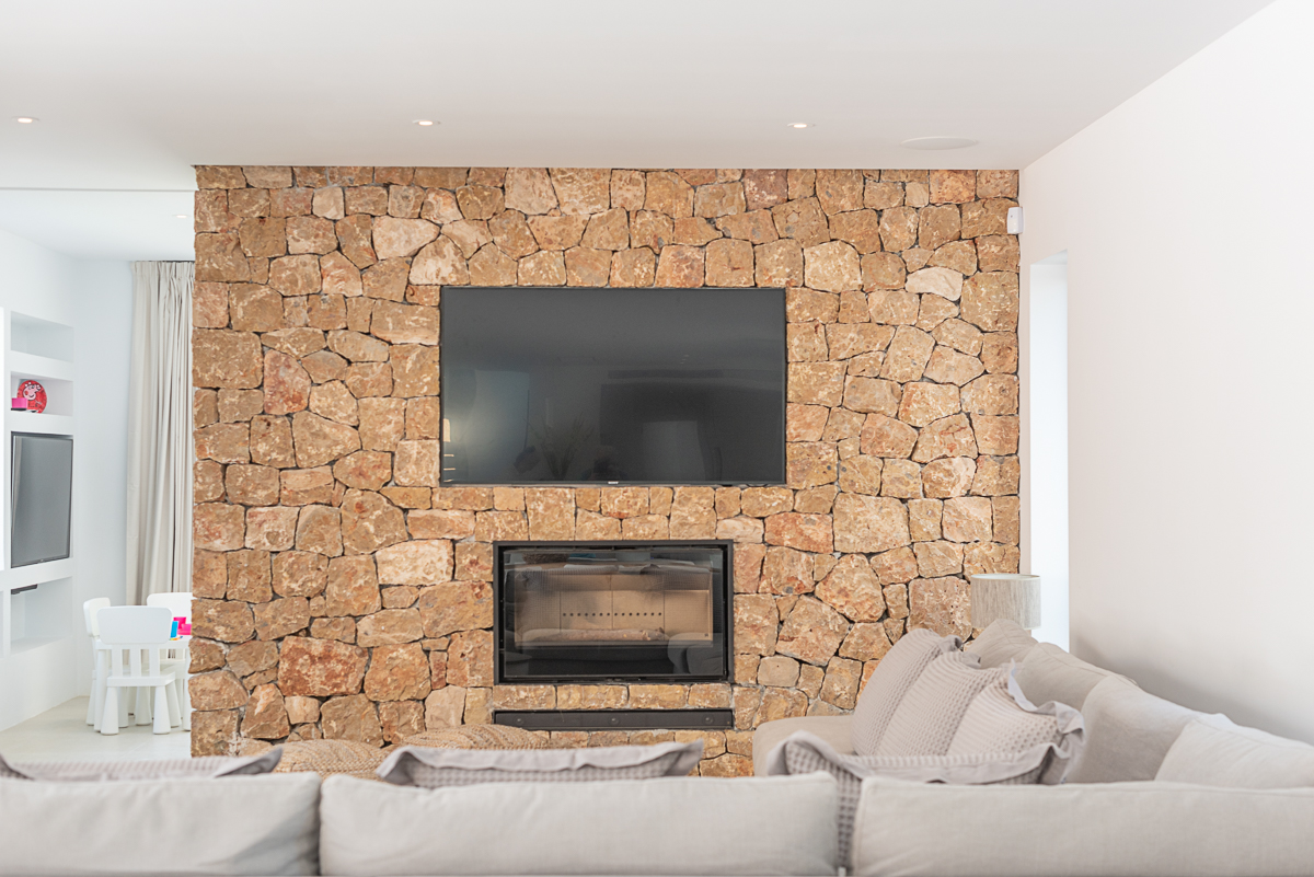 Resa estate modern villa for sale ibiza first line north stone wall.jpg